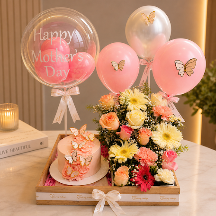 Mother’s Day basket with blueberry cake, fresh flowers and balloon setup with butterfly theme