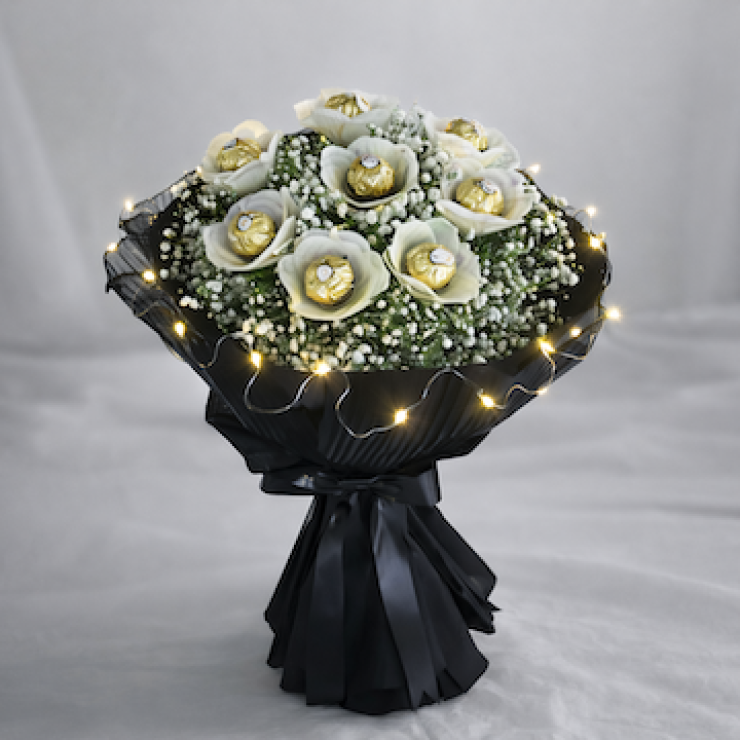 Ferrero Rocher chocolate bouquet with baby’s breath and LED lights wrapped in black tissue luxury glowing gift bouquet