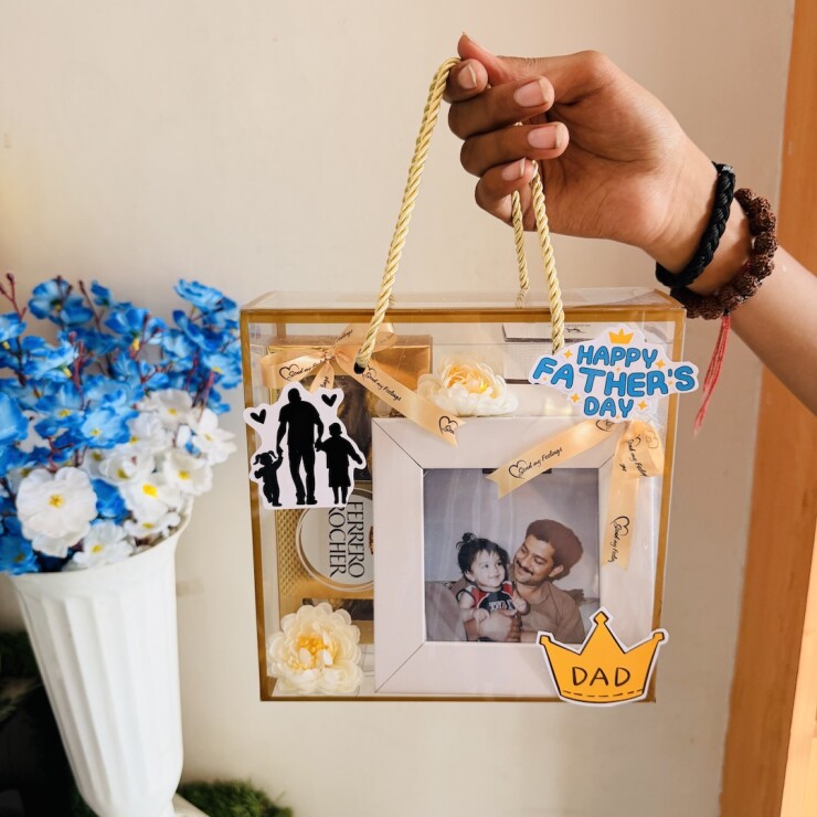 Premium transparent Father's Day gift box with personalized photo frame, Ferrero Rocher chocolates, floral decorations, and Father's Day theme by Send My Feelings.